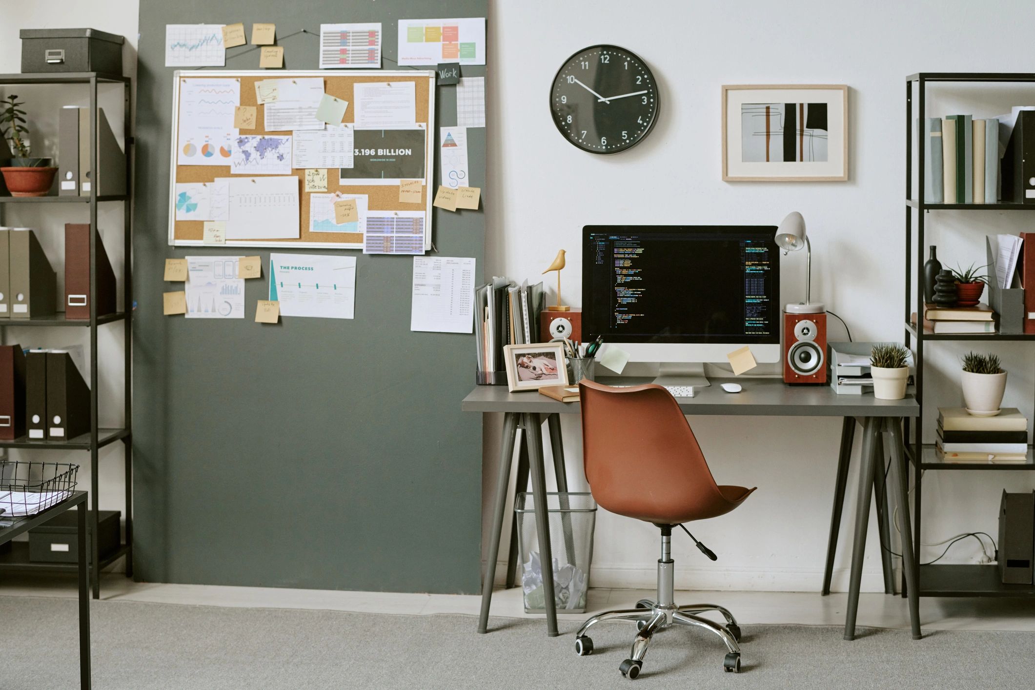 Workspace with computer and planning materials for creative project development